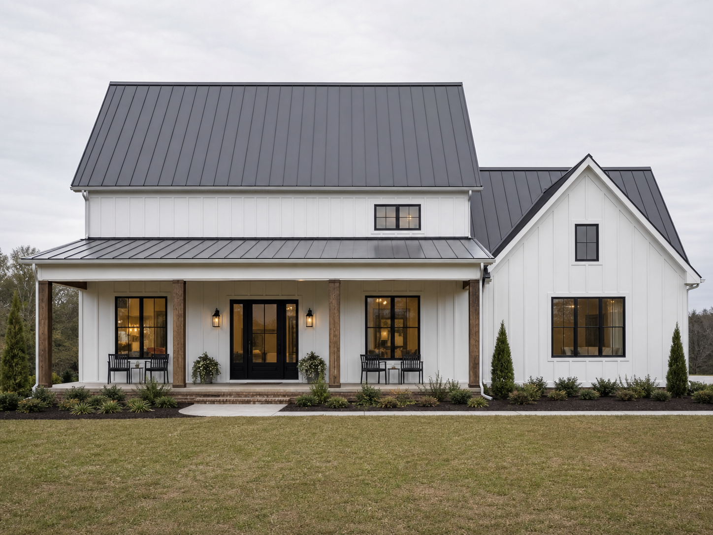 White farmhouse with several visible standing-seam metal roof planes